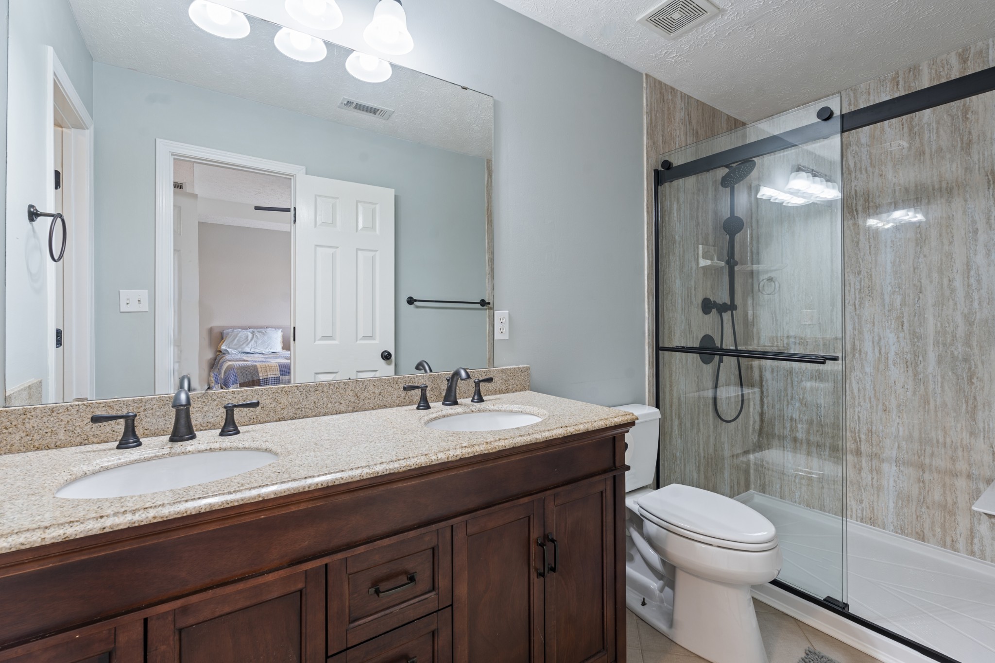 2213 New Port Drive Spring Hill, TN 37174 - Photo 16 of 32 a bathroom with a granite countertop sink toilet mirror and shower