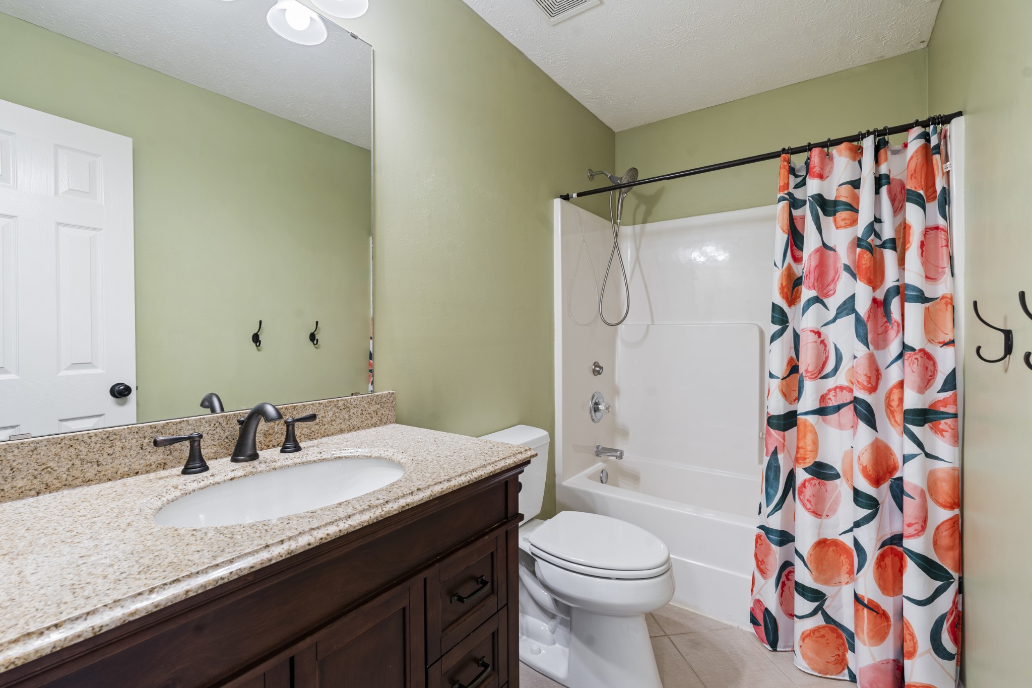 2213 New Port Drive Spring Hill, TN 37174 - Photo 20 of 32 a bathroom with a granite countertop sink toilet a shower and a mirror
