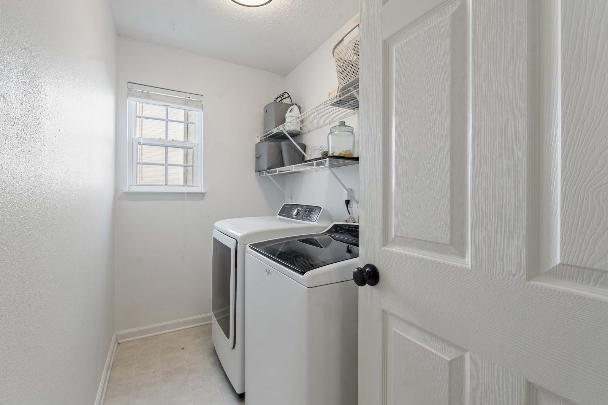 2213 New Port Drive Spring Hill, TN 37174 - Photo 21 of 32 a bathroom with a sink and a washer dryer