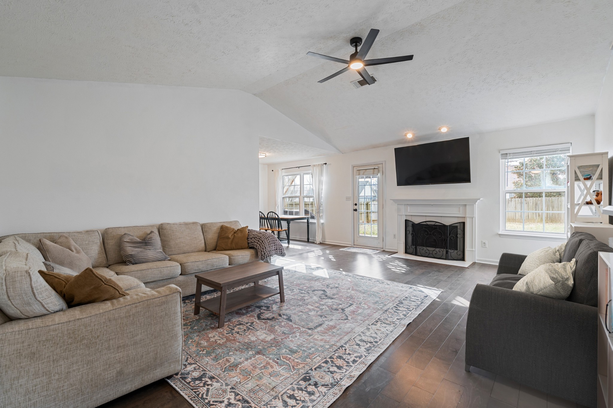 2213 New Port Drive Spring Hill, TN 37174 - Photo 5 of 32 a living room with furniture a fireplace and a flat screen tv