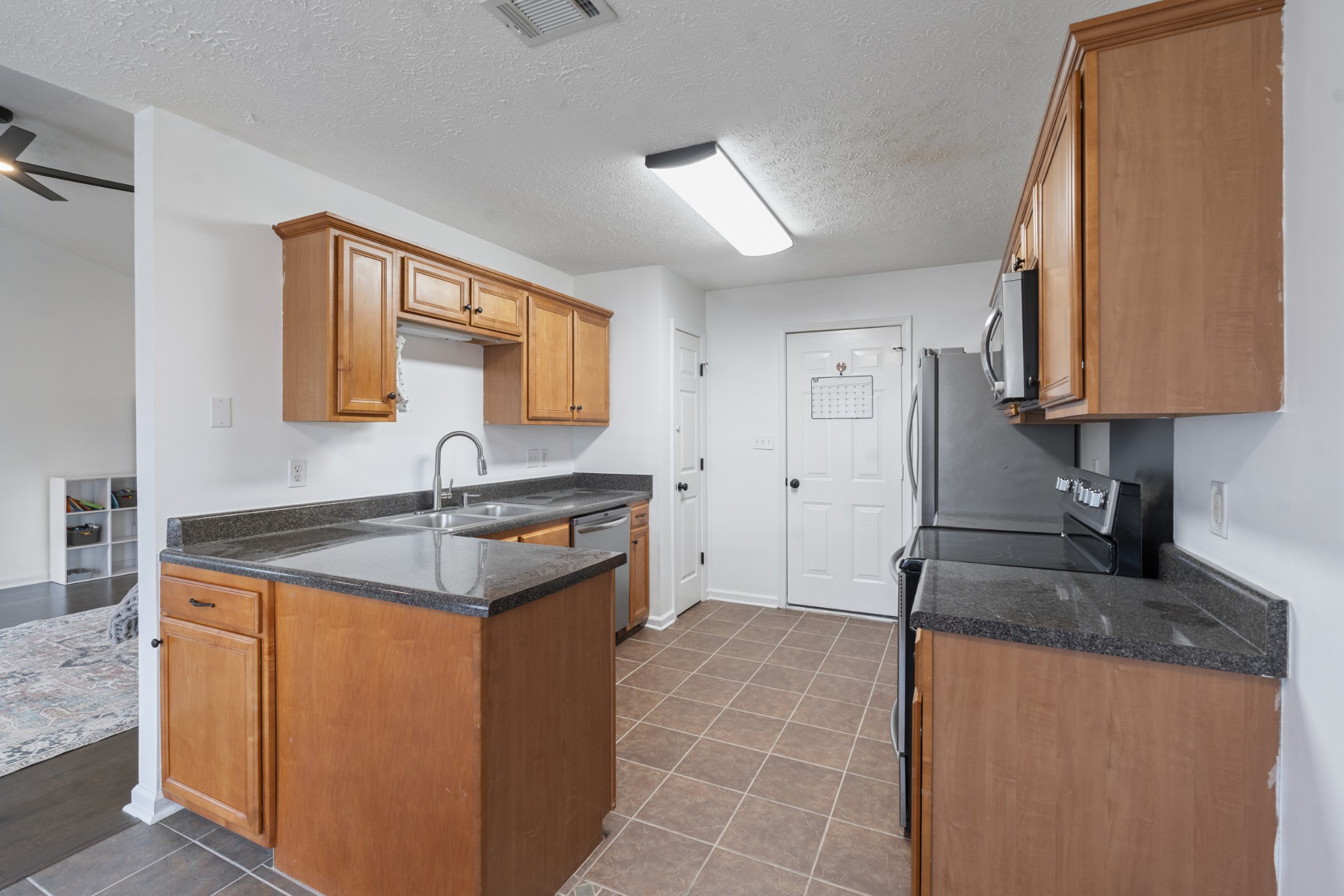 2213 New Port Drive Spring Hill, TN 37174 - Photo 10 of 32 a kitchen with stainless steel appliances granite countertop a sink stove and refrigerator