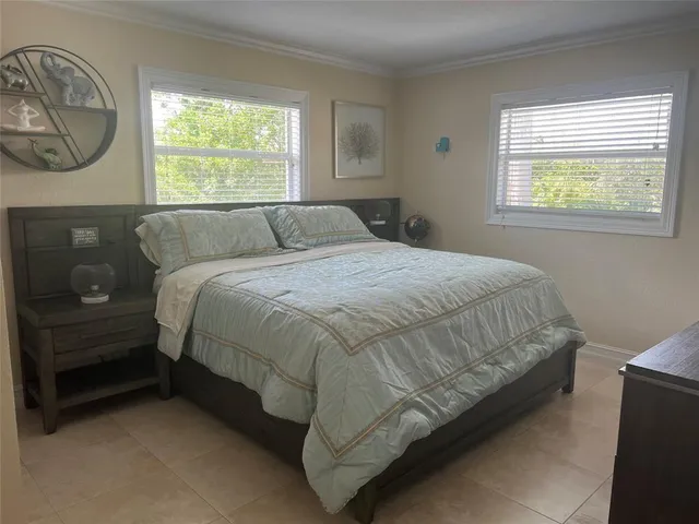 a bed sitting in a bedroom next to a window