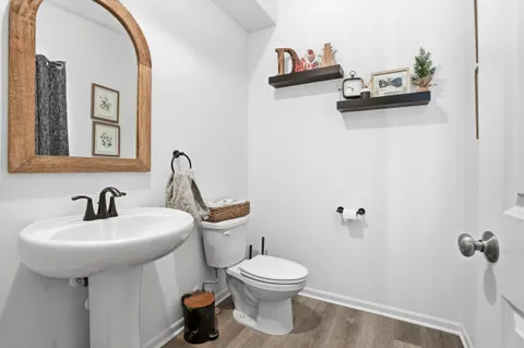 a bathroom with a sink mirror and toilet