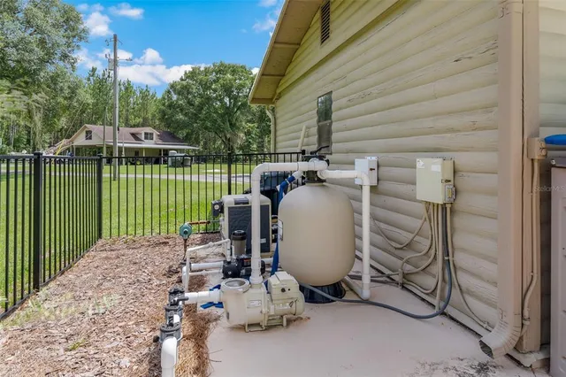 a living room with furniture a fireplace and a large window