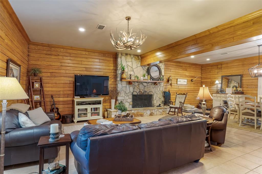 3771 184th Street Wellborn, FL 32094 - Photo 17 of 74 a living room with fireplace furniture and a flat screen tv