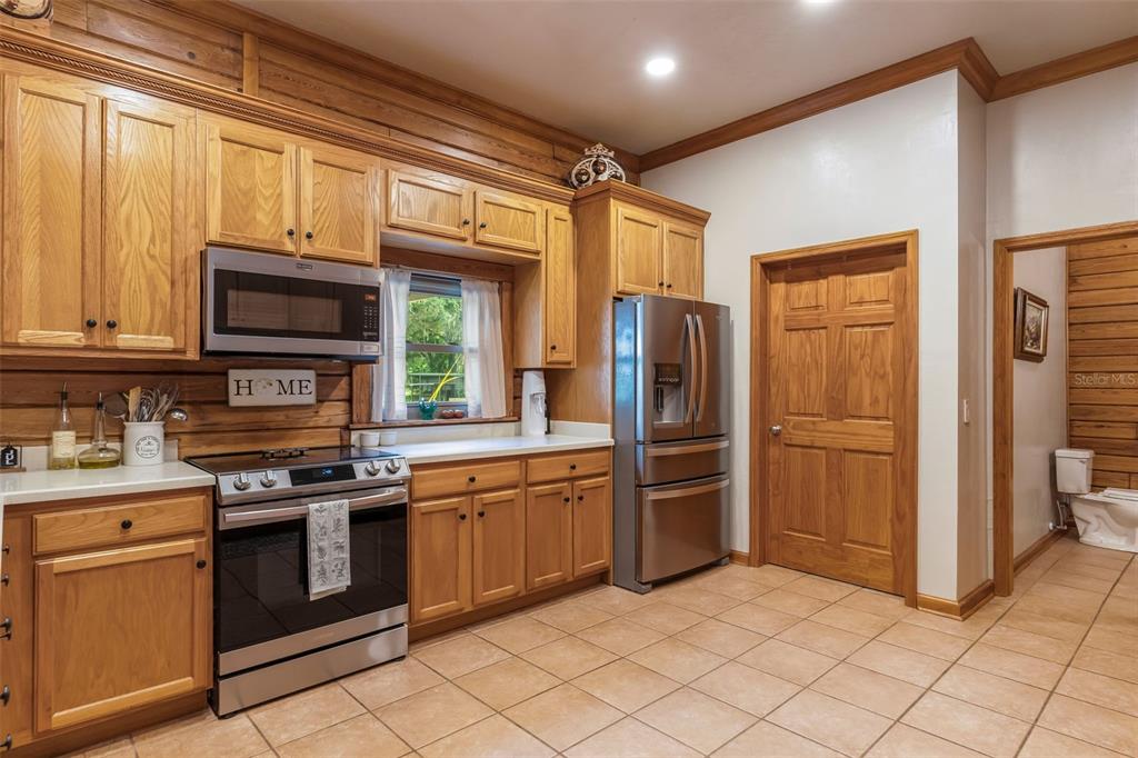 3771 184th Street Wellborn, FL 32094 - Photo 20 of 74 a kitchen with stainless steel appliances granite countertop cabinets and a stove top oven