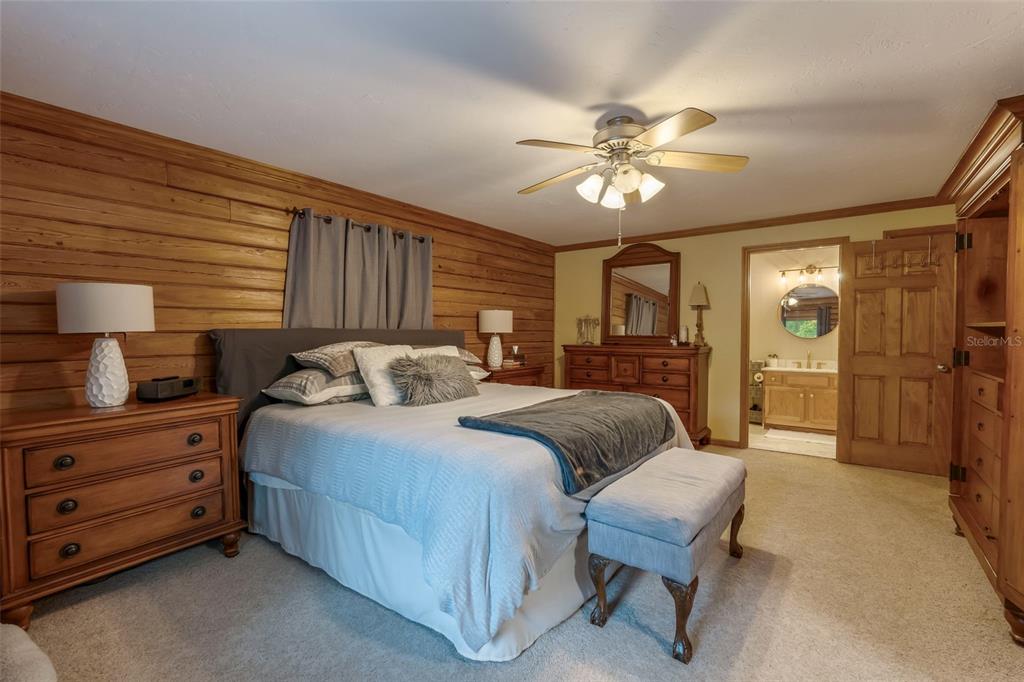 3771 184th Street Wellborn, FL 32094 - Photo 33 of 74 a spacious bedroom with a bed and a chandelier