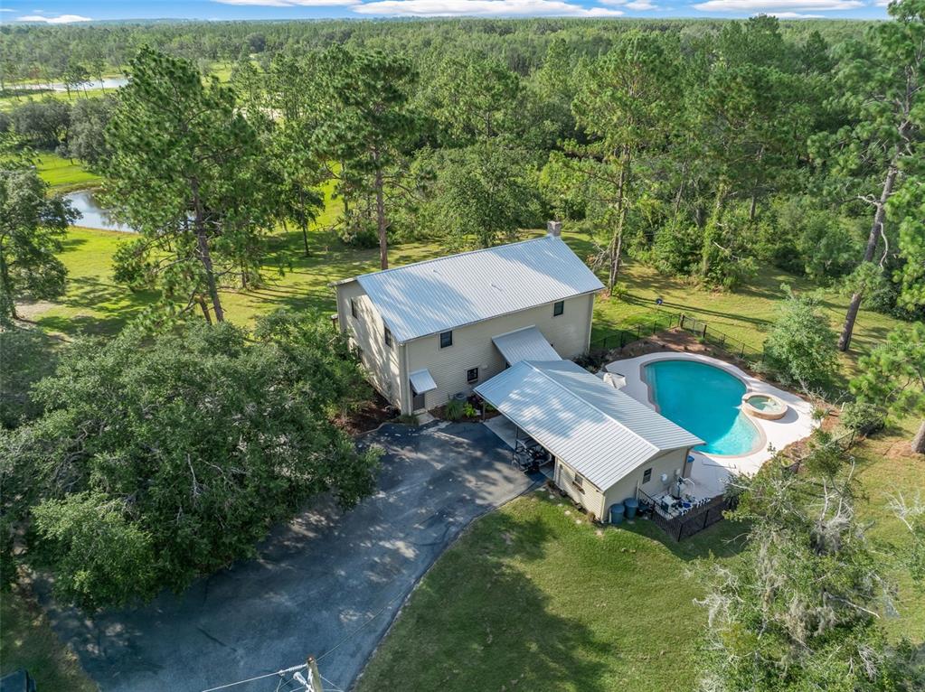 3771 184th Street Wellborn, FL 32094 - Photo 49 of 74 an aerial view of a house with swimming pool a yard and mountain view in back