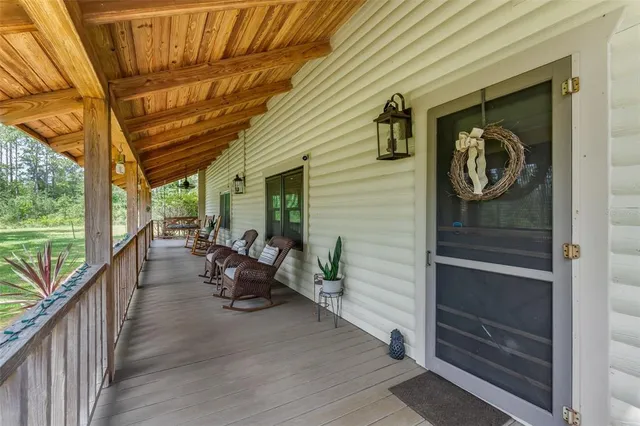 a view of a swimming pool with a yard and sitting area