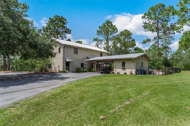 a view of a patio with table and chairs under an umbrella