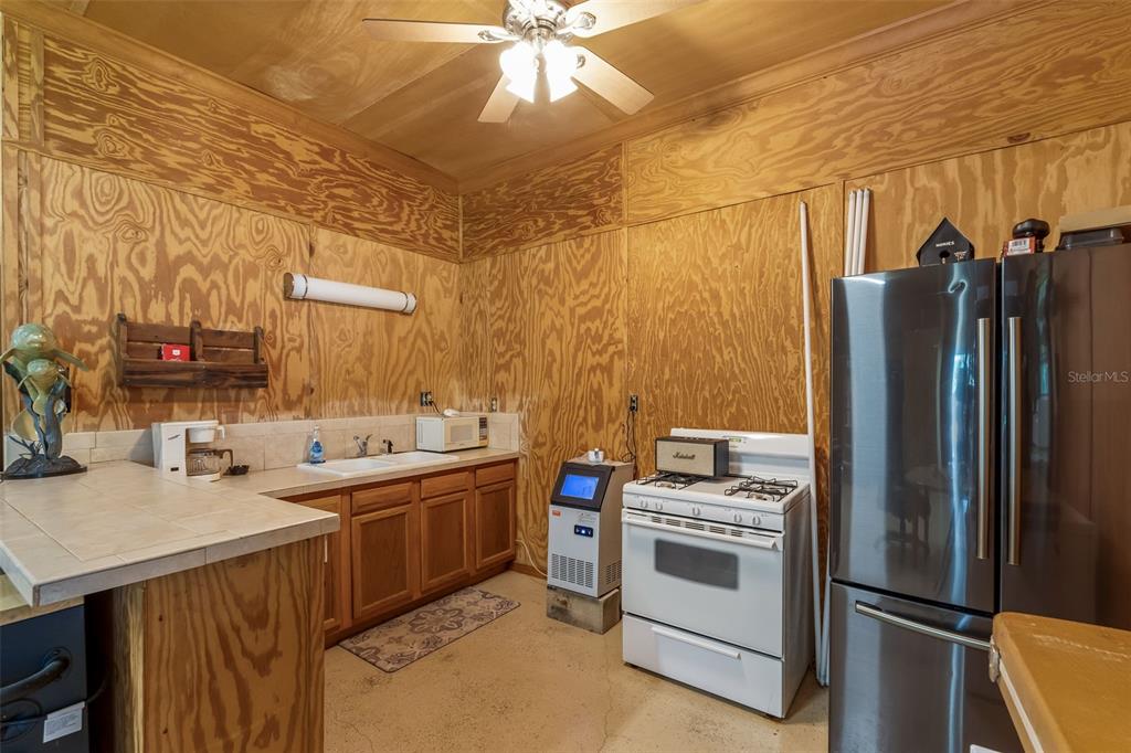 3771 184th Street Wellborn, FL 32094 - Photo 68 of 74 a kitchen that has a sink and a refrigerator