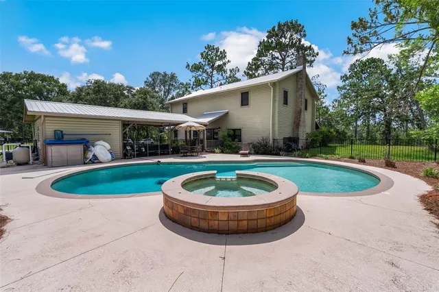 a view of a patio with table and chairs with wooden fence and plants