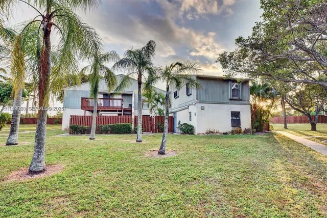 a house with palm tree in front of it