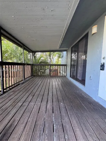 a view of balcony with wooden floor