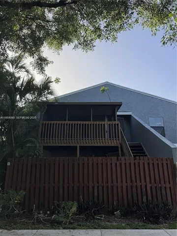 a view of balcony with wooden floor and fence