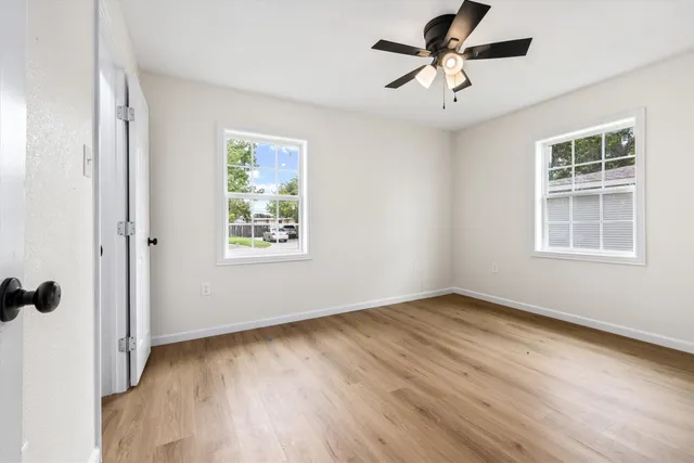 wooden floor in an empty room with a window