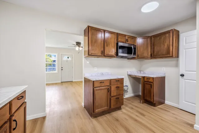 a kitchen with stainless steel appliances granite countertop wooden cabinets a stove top oven a sink and dishwasher