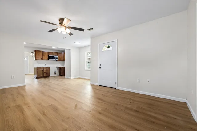 wooden floor in an empty room with a window