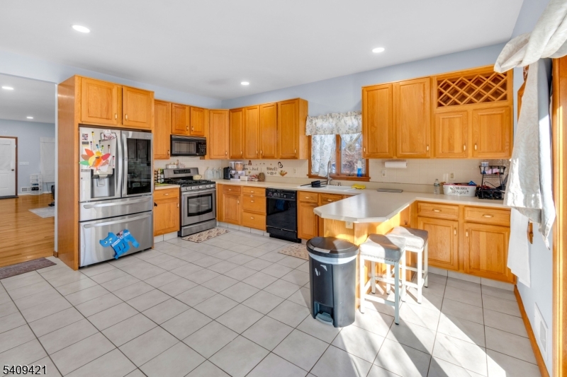 20 Center Street Butler, NJ 07405 - Photo 11 of 17 a kitchen with stainless steel appliances kitchen island granite countertop a sink and cabinets