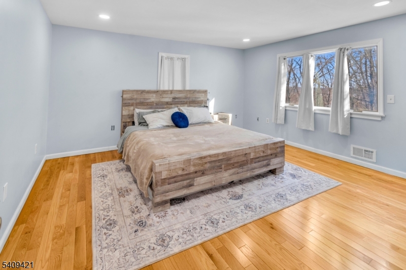 20 Center Street Butler, NJ 07405 - Photo 15 of 17 a bedroom with a bed and wooden floor