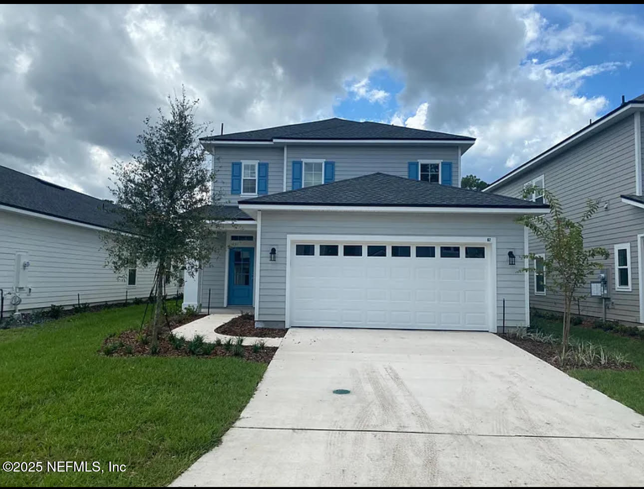 a front view of a house with a garden