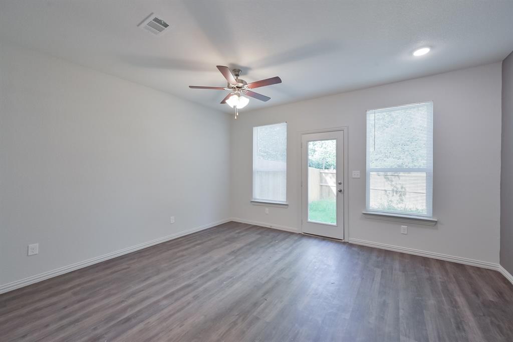 1716 East Powell Avenue Fort Worth, TX 76104 - Photo 7 of 13 wooden floor in an empty room with a window