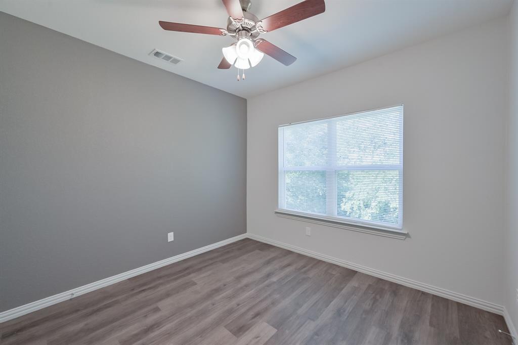 1716 East Powell Avenue Fort Worth, TX 76104 - Photo 10 of 13 an empty room with a window and a fan