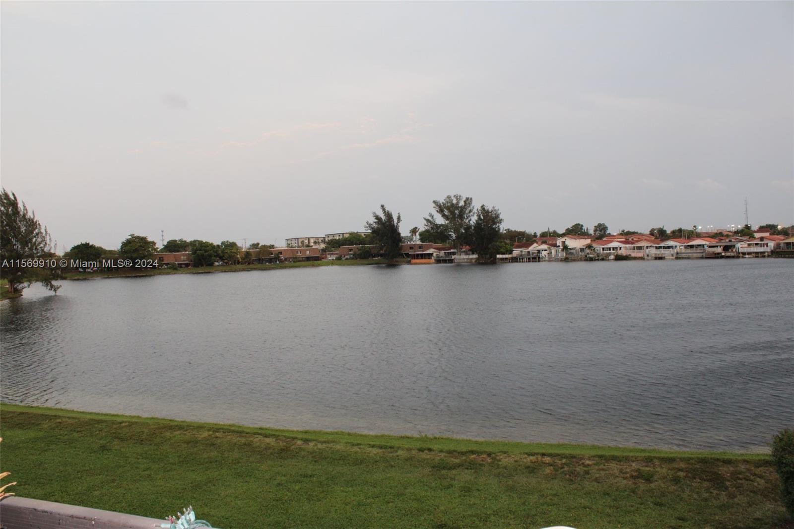 a view of a lake with houses in the background