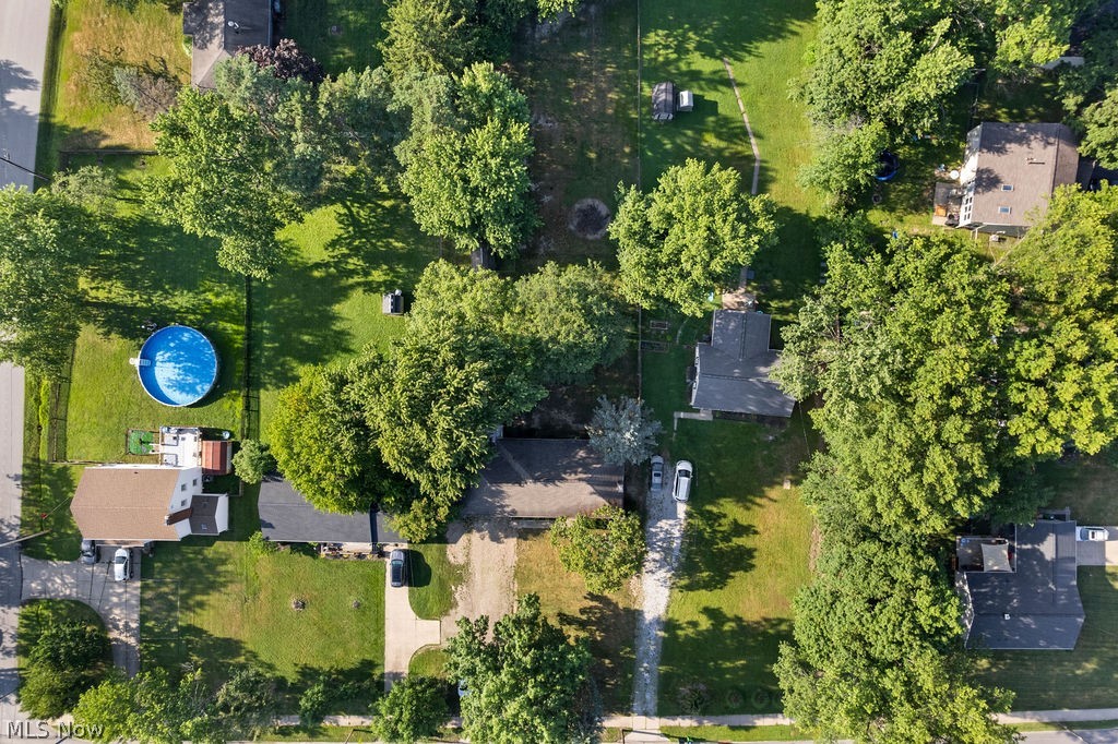 1903 Graham Road Stow, OH 44224 - Photo 25 of 29 Expansive property featuring a vibrant green lawn, mature trees providing ample shade, an above-ground pool, and a storage shed