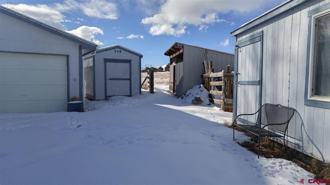 Undisclosed Address Cedaredge, CO 81413 - Photo 13 of 18 There are several storage buildings on the property, clustered around the garage.