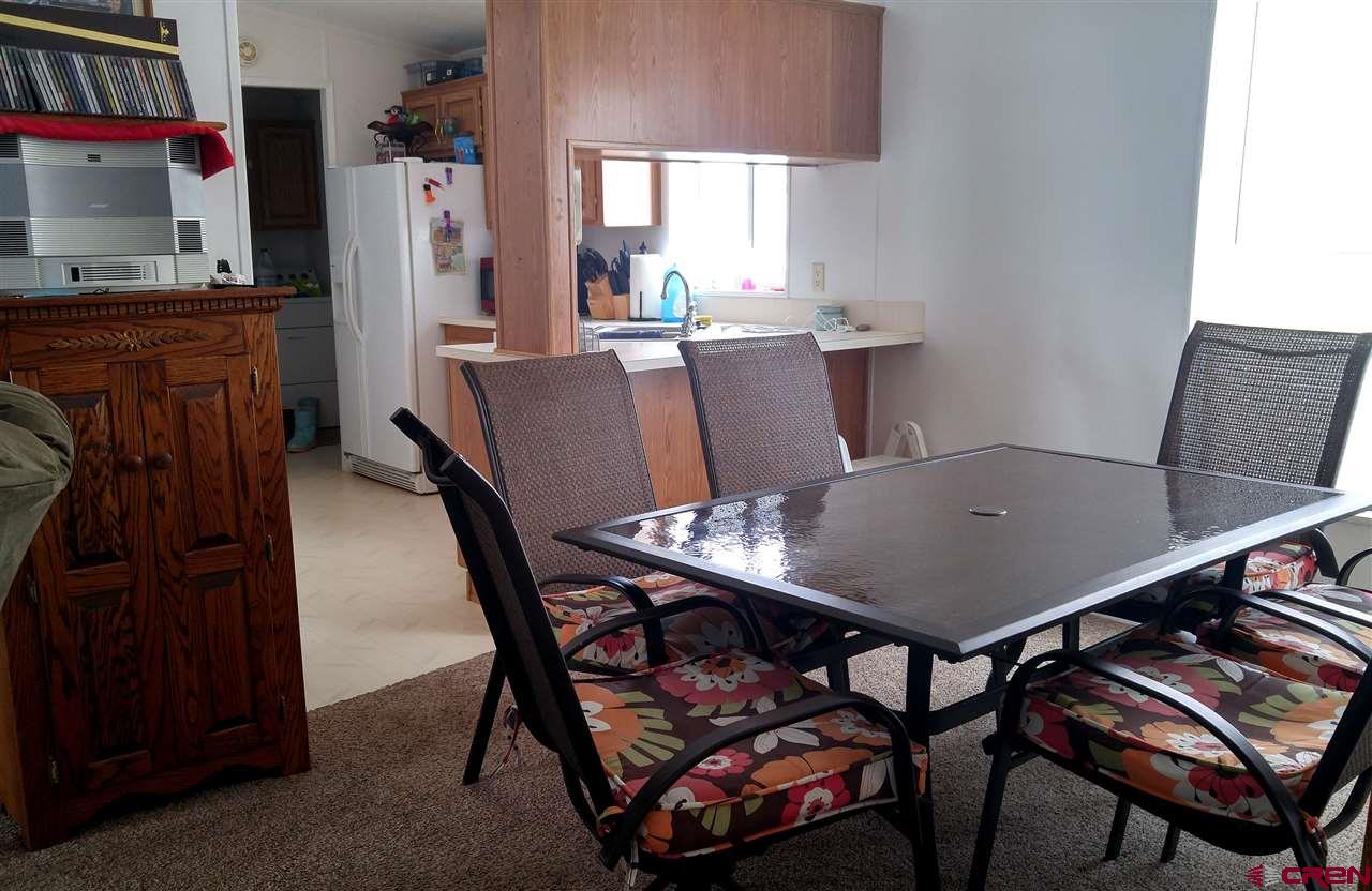 Undisclosed Address Cedaredge, CO 81413 - Photo 5 of 18 The dining area is off the kitchen and open to the living room.