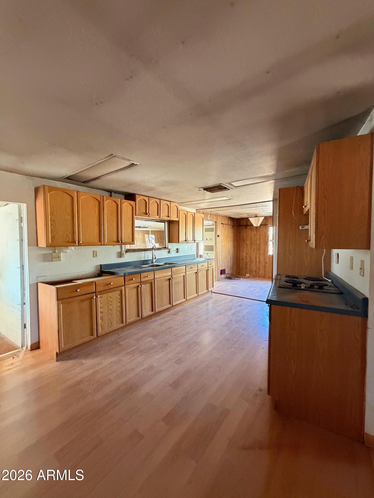 1144 West Edwards Lane Benson, AZ 85602 - Photo 10 of 30 a large kitchen with stainless steel appliances granite countertop a large counter top and a stove