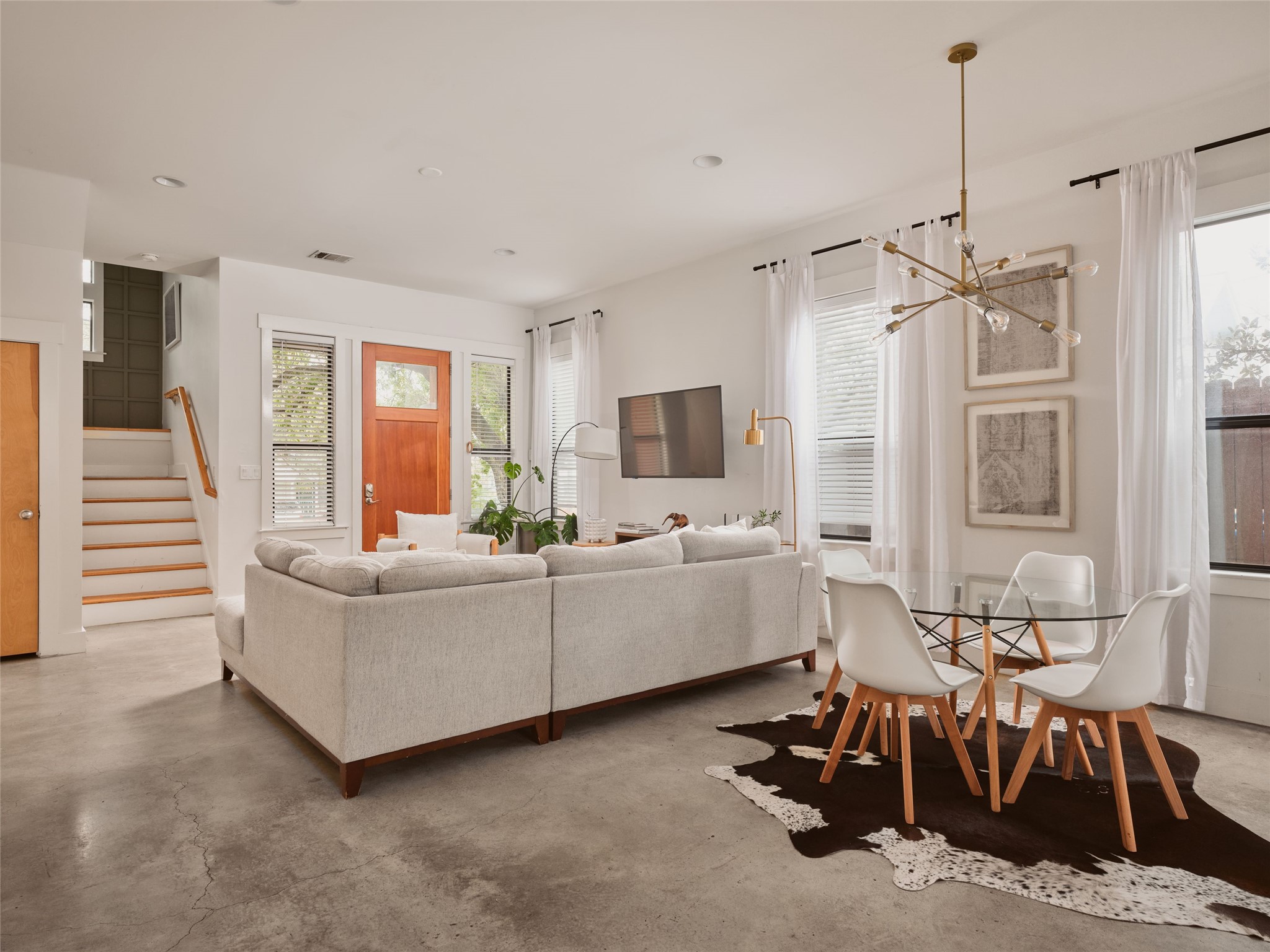 2002 East 13th Street, Unit A Austin, TX 78702 - Photo 9 of 37 Living room featuring finished concrete floors, stairs, healthy amount of natural light, and recessed lighting