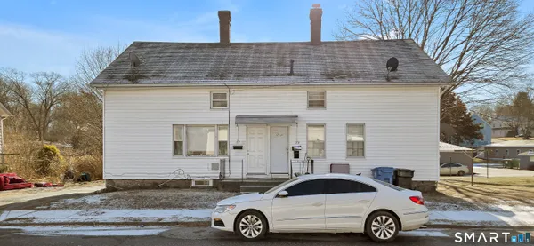 a front view of a house with parking space