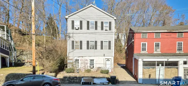 a front view of a residential apartment building with a yard