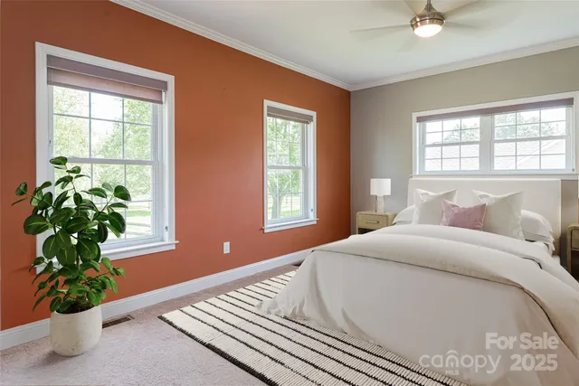 a bed sitting in a bedroom next to a window