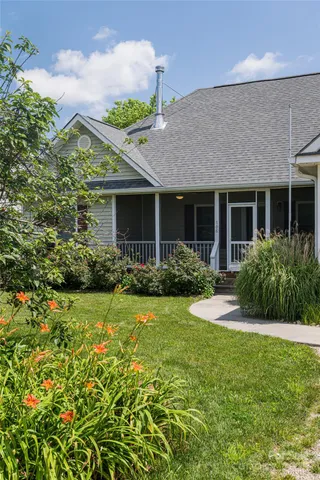 a front view of house with yard and green space