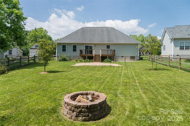 a view of a house with a yard and sitting area