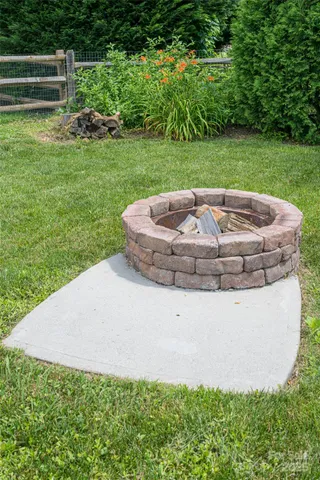 a view of a house with a yard and green space