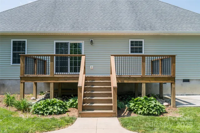 a front view of a house with plants