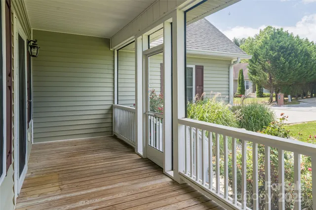 a view of a balcony with wooden floor and fence