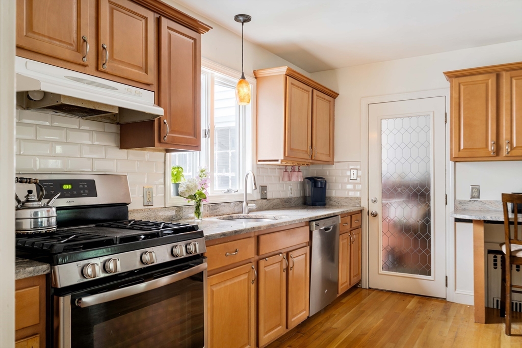7 St Marys Road Milton, MA 02186 - Photo 8 of 31 a kitchen with a sink stove and refrigerator