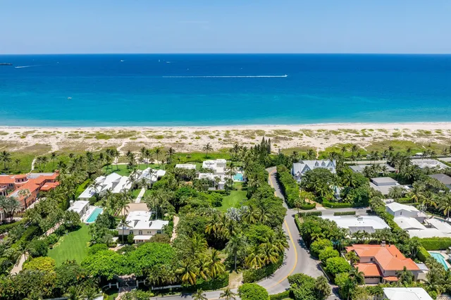 an aerial view of a house with a yard and lake view