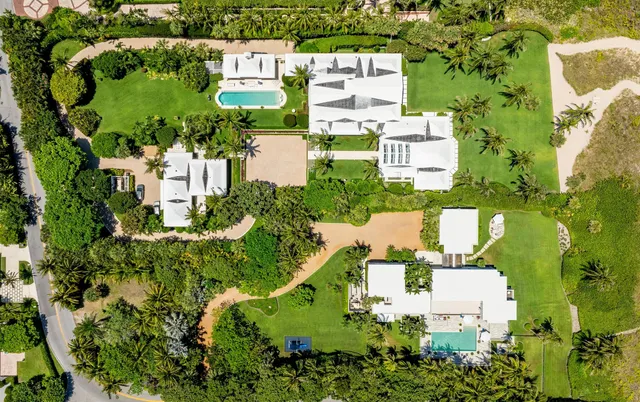 a front view of house with swimming pool and green space