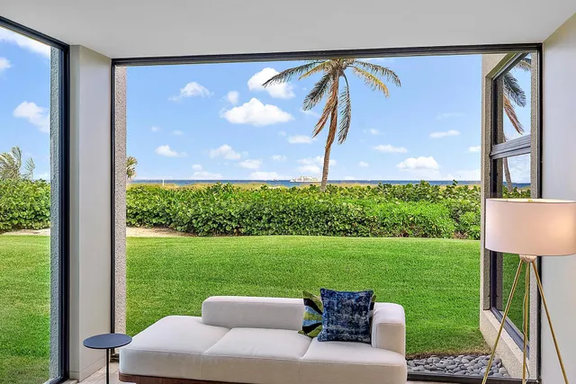 a view of backyard with swimming pool and outdoor seating