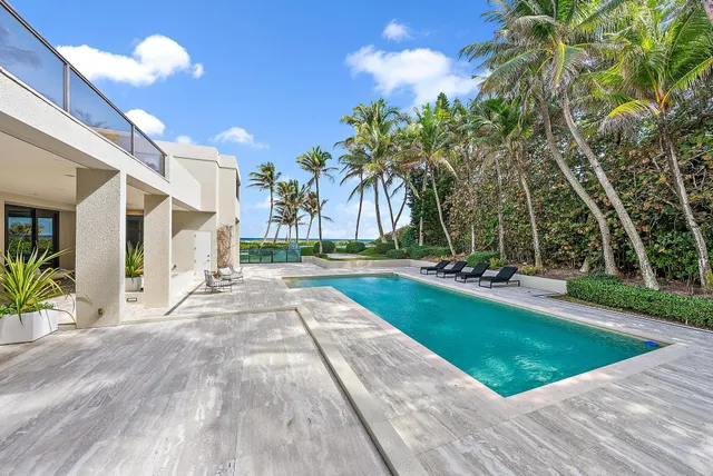 a bed sitting in a bedroom next to a large window with outer view