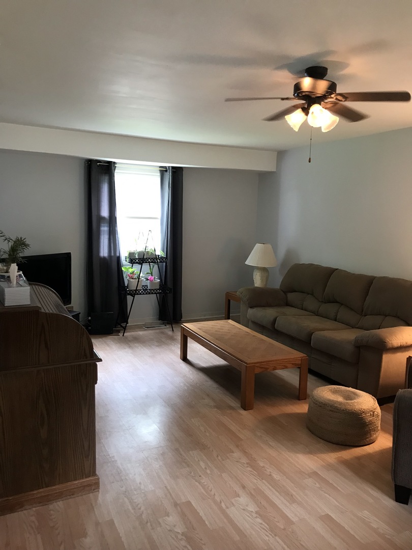 547 White Oak Road Bolingbrook, IL 60440 - Photo 2 of 19 a living room with furniture and a chandelier