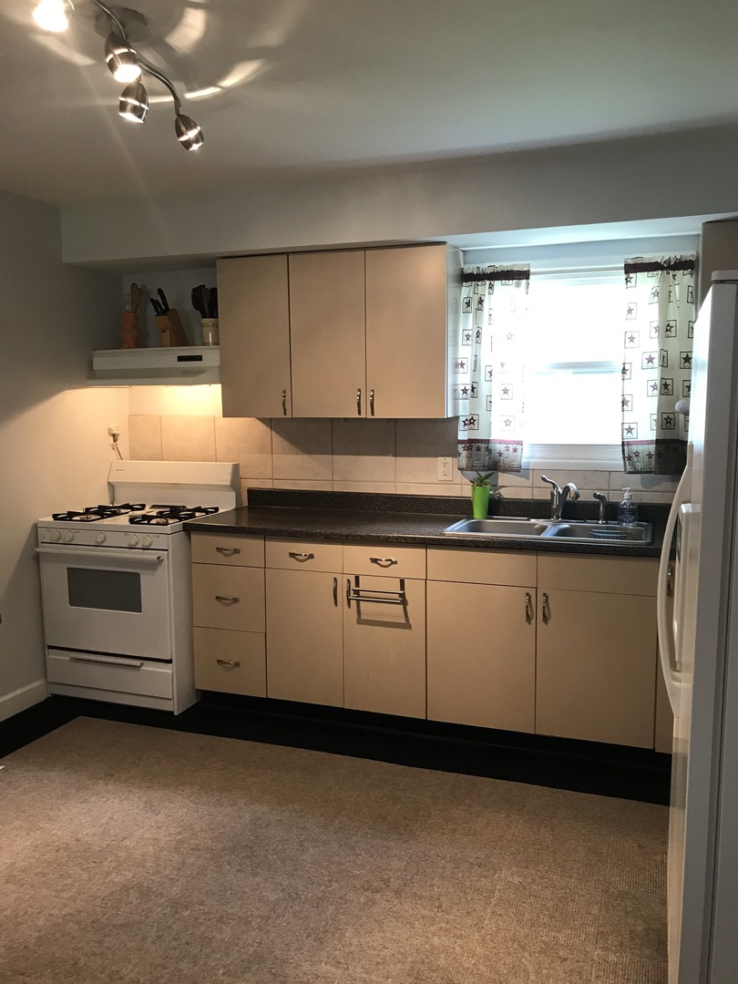 547 White Oak Road Bolingbrook, IL 60440 - Photo 5 of 19 a kitchen with granite countertop a sink and a stove
