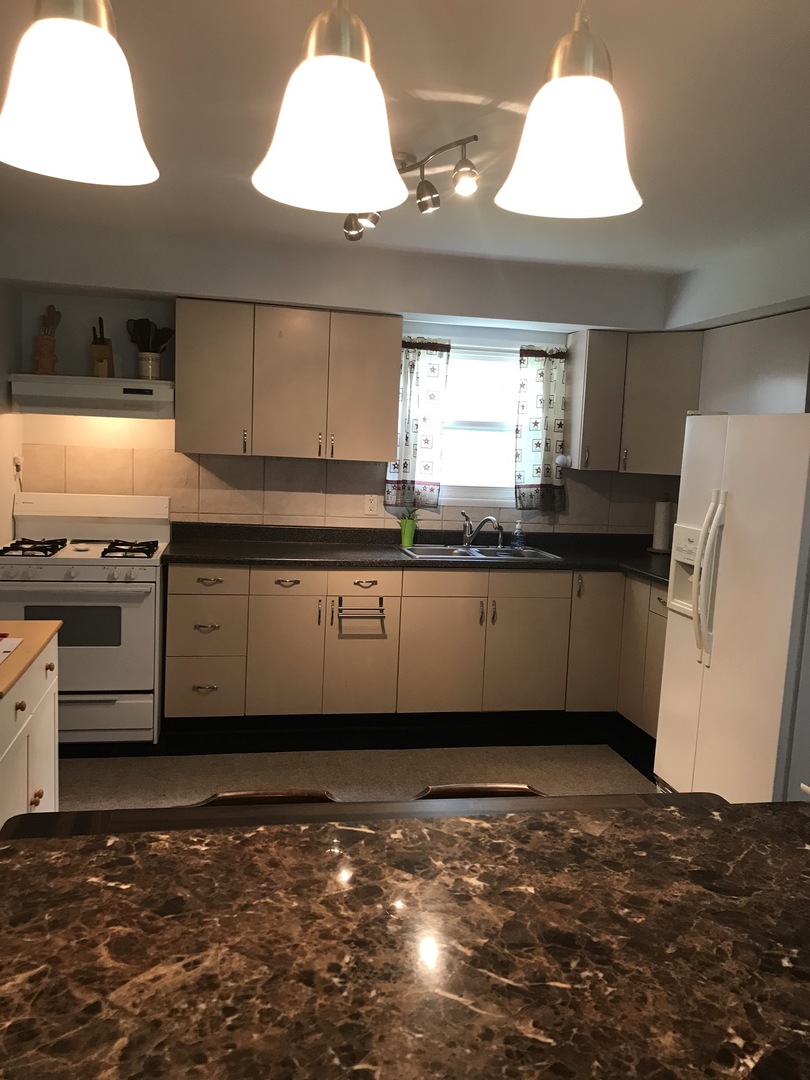 547 White Oak Road Bolingbrook, IL 60440 - Photo 6 of 19 a kitchen with stainless steel appliances granite countertop a sink and a stove