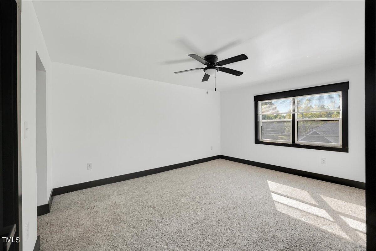 321 East Umstead Street Durham, NC 27707 - Photo 11 of 22 an empty room with windows and ceiling fan